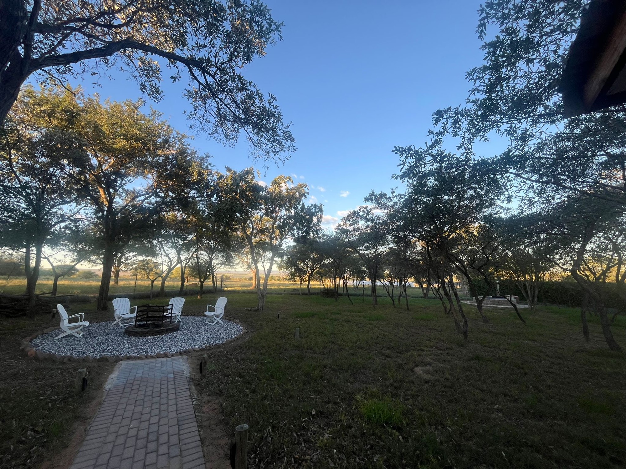 Golden hour over a safari lodge firepit